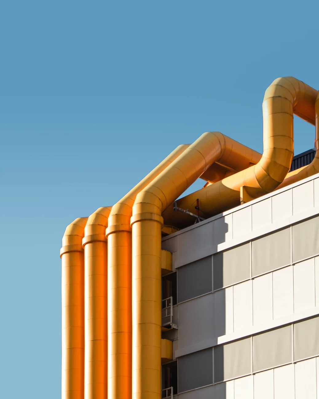 Yellow pipes against a blue sky